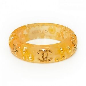 Chanel Coco Mark resin bangle bracelet in beige